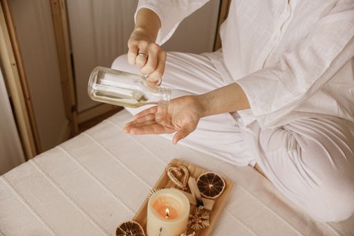 A high angle shot of a female using a body oil for spa