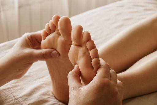A closeup shot of masseur massaging a female's feet