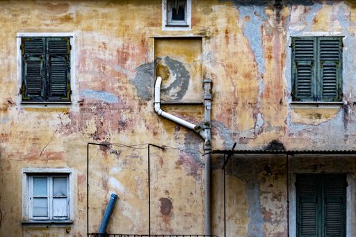 A closeup of an old grungy house wall