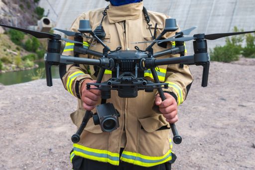 A firefighter operating a drone in search and rescue