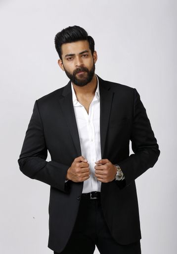 An Indian elegant male with a polo suit holding the jacket isolated on white background