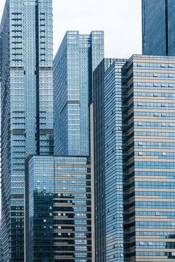 This image captures a bustling cityscape, with a row of modern skyscrapers dominating the skyline