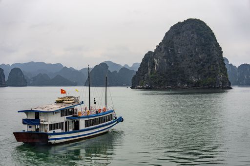 An aerial view of a cruise ship navigating through Halong Bay in Vietnam, Southeast Asia