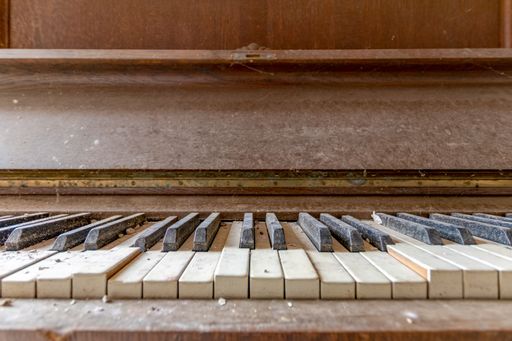 Keyboard of an old and dirty wooden piano