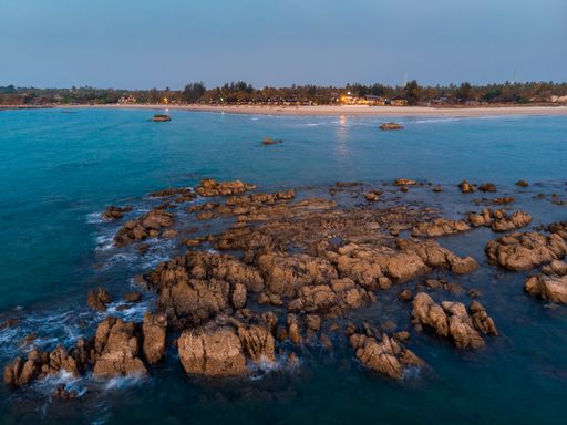 A beautiful shot of the sea with cliffs and rocks during sunset