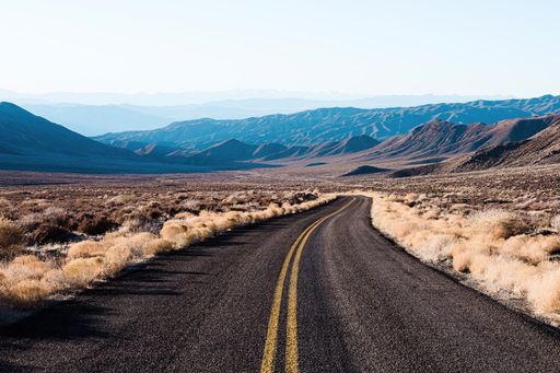 An empty road on a mountain field