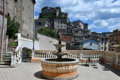 A fountain in a street of a medieval town near Rome.