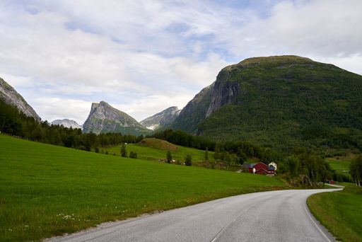 A beautiful mountainous landscape with greenery and cabins in Western Norway