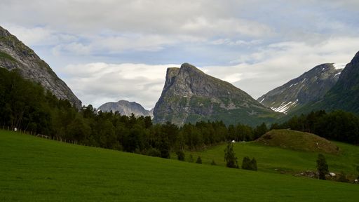 A beautiful mountainous landscape with greenery and cabins in Western Norway