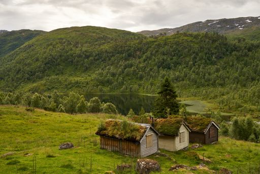 A beautiful mountainous landscape with greenery and cabins in Western Norway