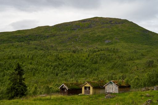 A beautiful mountainous landscape with greenery and cabins in Western Norway