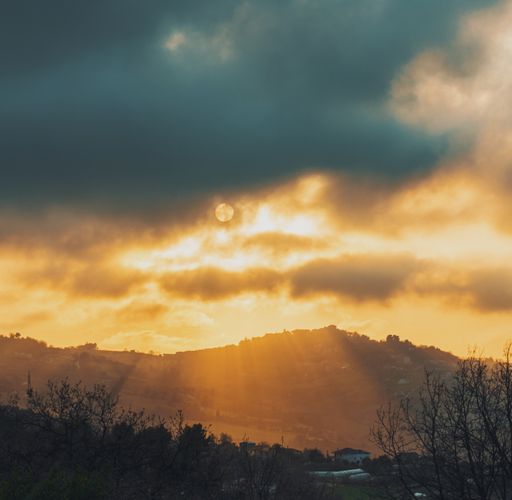 A beautiful rural landscape under a cloudy sunset sky