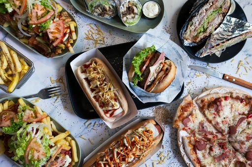 A top view of a variety of freshly-prepared dishes arranged on multiple plates.
