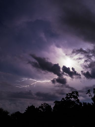 An awe-inspiring image of a vibrant stormy sky with a brilliant lightning bolt illuminating the center