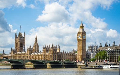 A scenic view of the iconic Palace of Westminster and the world-famous clock tower, Big Ben, situated on the River Thames in London, England