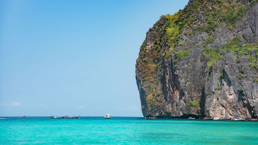 A ccenic view of pure blue sea, boats and distant mountains, Phuket and Phi Phi Island, Thailand