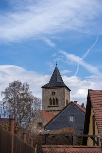 A vertical shot of a typical church in Thuringia under the sunlight and a blue cloudy sky in Germany