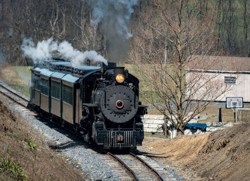 A train traveling along railroad tracks
