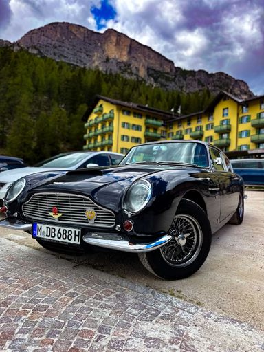 A Low angle shot of a  shiny dark blue Austin Martin classic car DB5