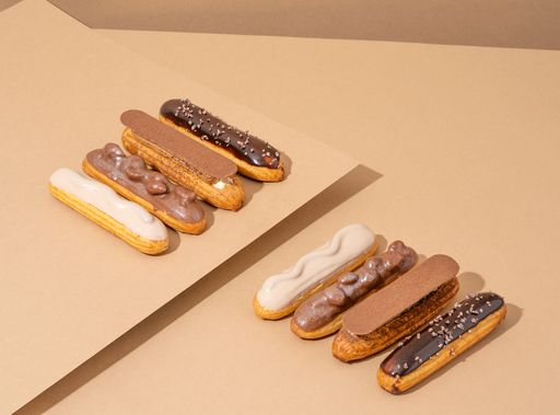 A set of delicious glazed donuts in a variety of flavors, arranged on a wooden table in an inviting display