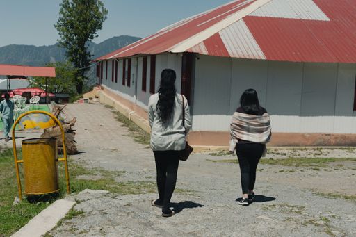 Some tourists walking through the streets of Shogran, Pakistan, enjoying the scenery
