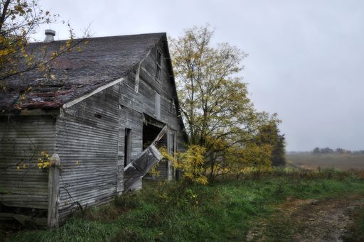 A beautiful shot of a weathered wooden barn in the rural areas in Missouri on a gloomy day