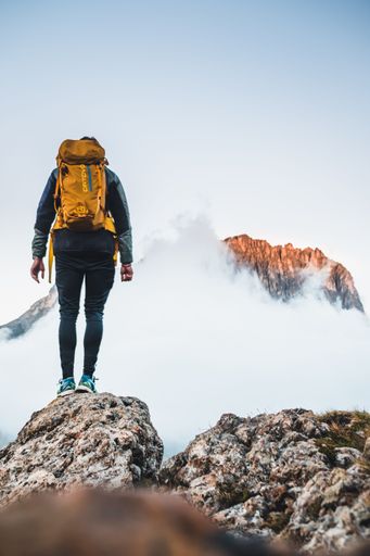 A daring climber conquering the jagged mountainous heights of the Dolomites, part of the Alps in Italy's South Tyrol region