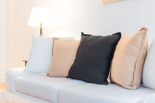 A cozy and inviting living room with a comfortable couch and lamp
