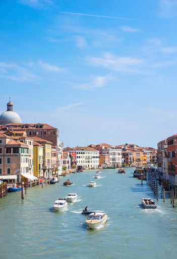 VENICE, Row of boats on a canal along buildings in the city center