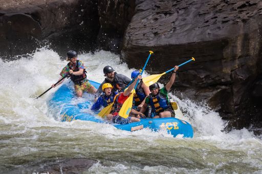 A diverse group of people rafting together in a flowing river