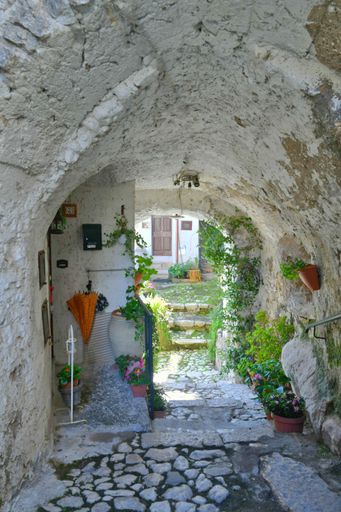 A narrow street among the old houses of a medieval town near Rome.