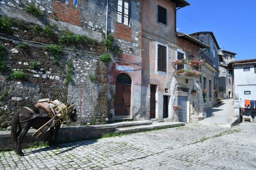 A small square among the old houses of a medieval town near Rome.