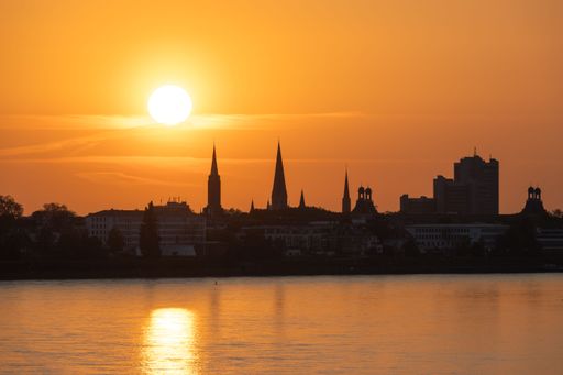 A gorgeous view of Bonn standing against a picturesque, golden sunset