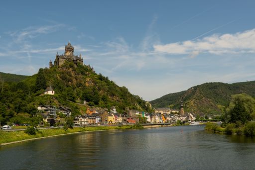 The town of Cochem, at the river Moselle, in Germany, on a summer's day. The famous Castle Reichsburg on top of a hill on the lef