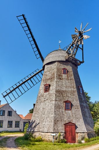 Svaneke, Denmark - June 28, 2019. Svanemollen (Swan Mill) is a wooden smock mill built in 1857 It is the wooden smock mill with its onion cap.