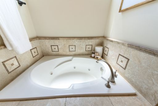 A modern interior of a bathroom with a big bathtub
