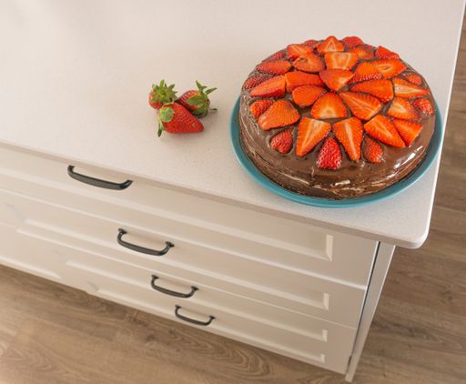 delicious strawberry cake with chocolate on a white marble table