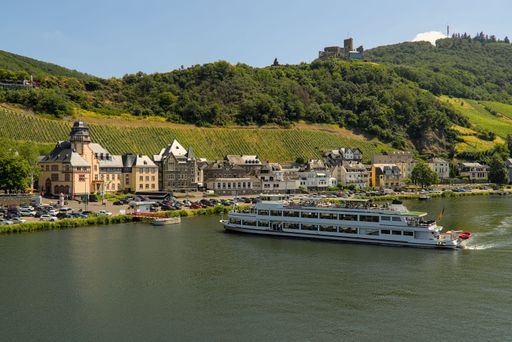 An aerial view of a cruise ship maneuvering on the river Moselle in Bernkastel-Kues, Germany