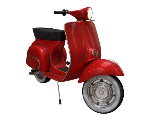 A stylish red Vespa scooter isolated on the white background