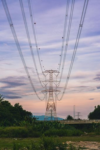 A low angle of electricity poles at sunset