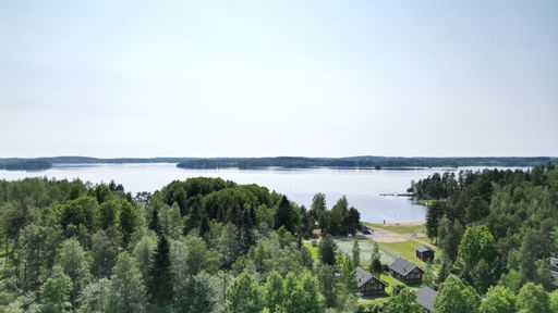 An aerial view of a tranquil lake surrounded by residential properties nestled in a sprawling landscape