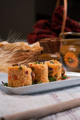 The fried chicken and rice with vegetables served on a white plate