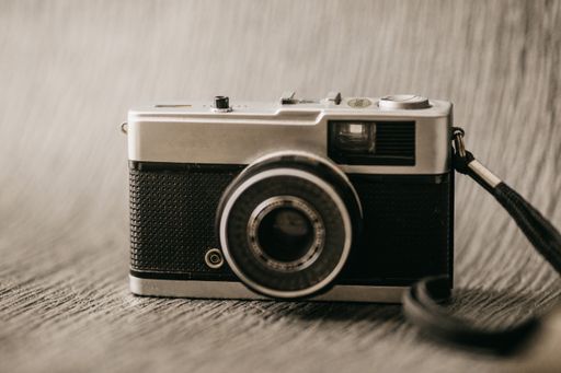 A closeup shot of a film camera on a textured background