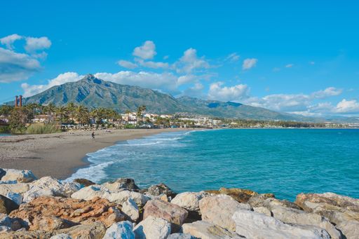 The beautiful scenery of people by the sand in Marbella, Spain
