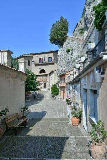 A narrow street among the old houses of a medieval town in the Lazio region.