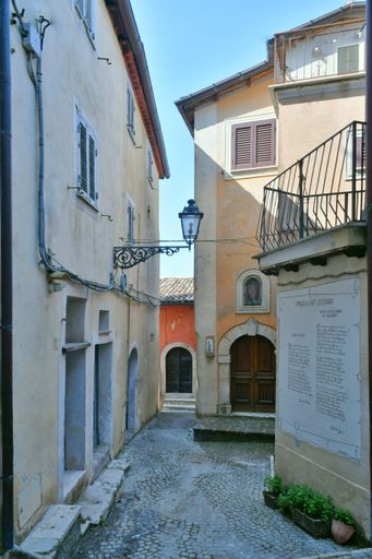 A narrow street among the old houses of a medieval town in the Lazio region.