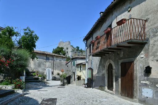 A narrow street among the old houses of a medieval town in the Lazio region.