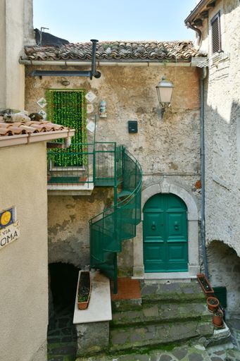 A narrow street among the old houses of a medieval town in the Lazio region.