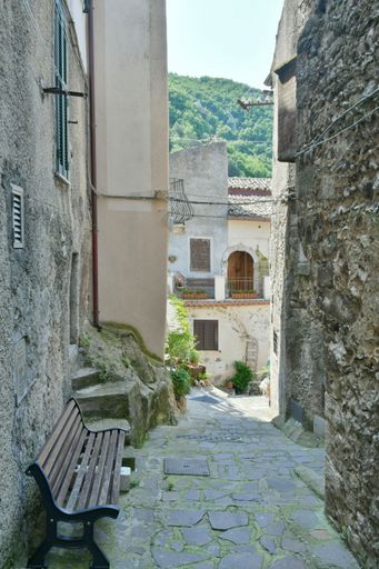 A narrow street among the old houses of a medieval town in the Lazio region.