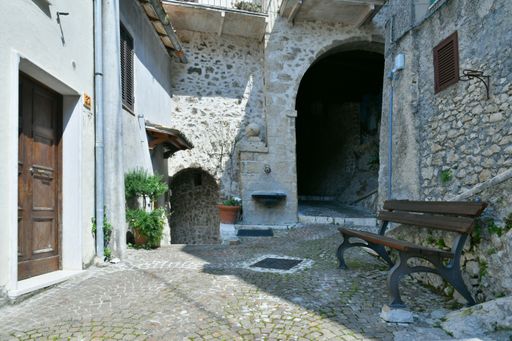 A narrow street among the old houses of a medieval town in the Lazio region.